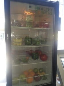 Refrigerated case with fresh fruit and vegetables.