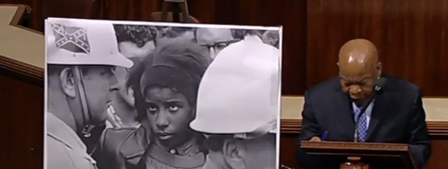 Rep. James Clyburn (D-SC)  shows picture of policeman with Confederate battle flags on their helmets at Edmund Pettus bridge march.