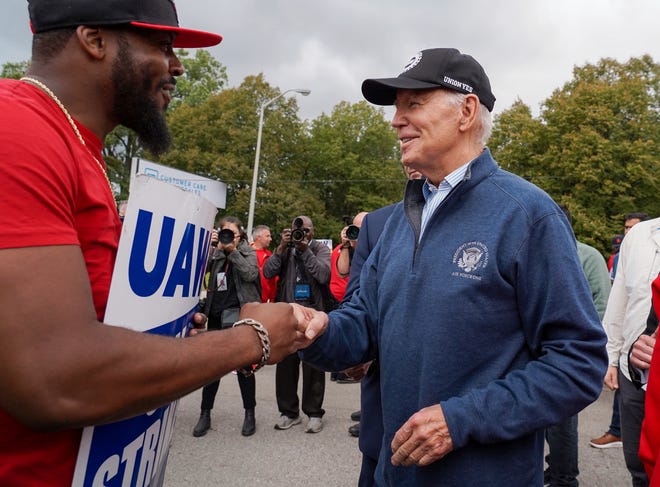 President Joe Biden speaks with workers picketing at General Motors Willow Run Redistribution in Van Buren Township on Tuesday, Sept. 26, 2023, during a stop in Michigan.