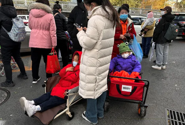 people stand next children sitting 862353200 china and world panic over white lung syndrome in children